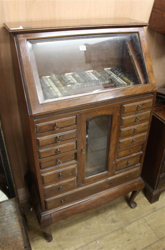 A 1920s walnut opticianss cabinet W.73cm